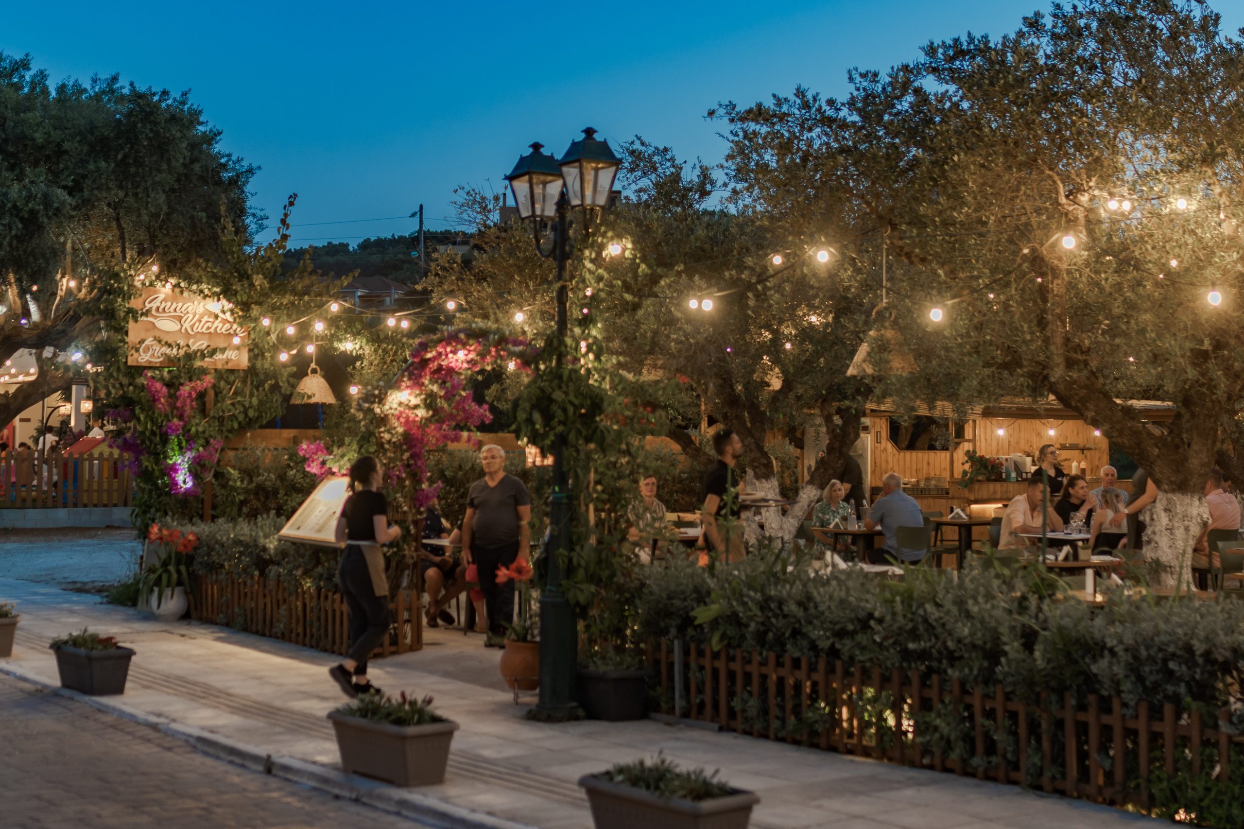 Anna's Kitchen dining area under olive trees